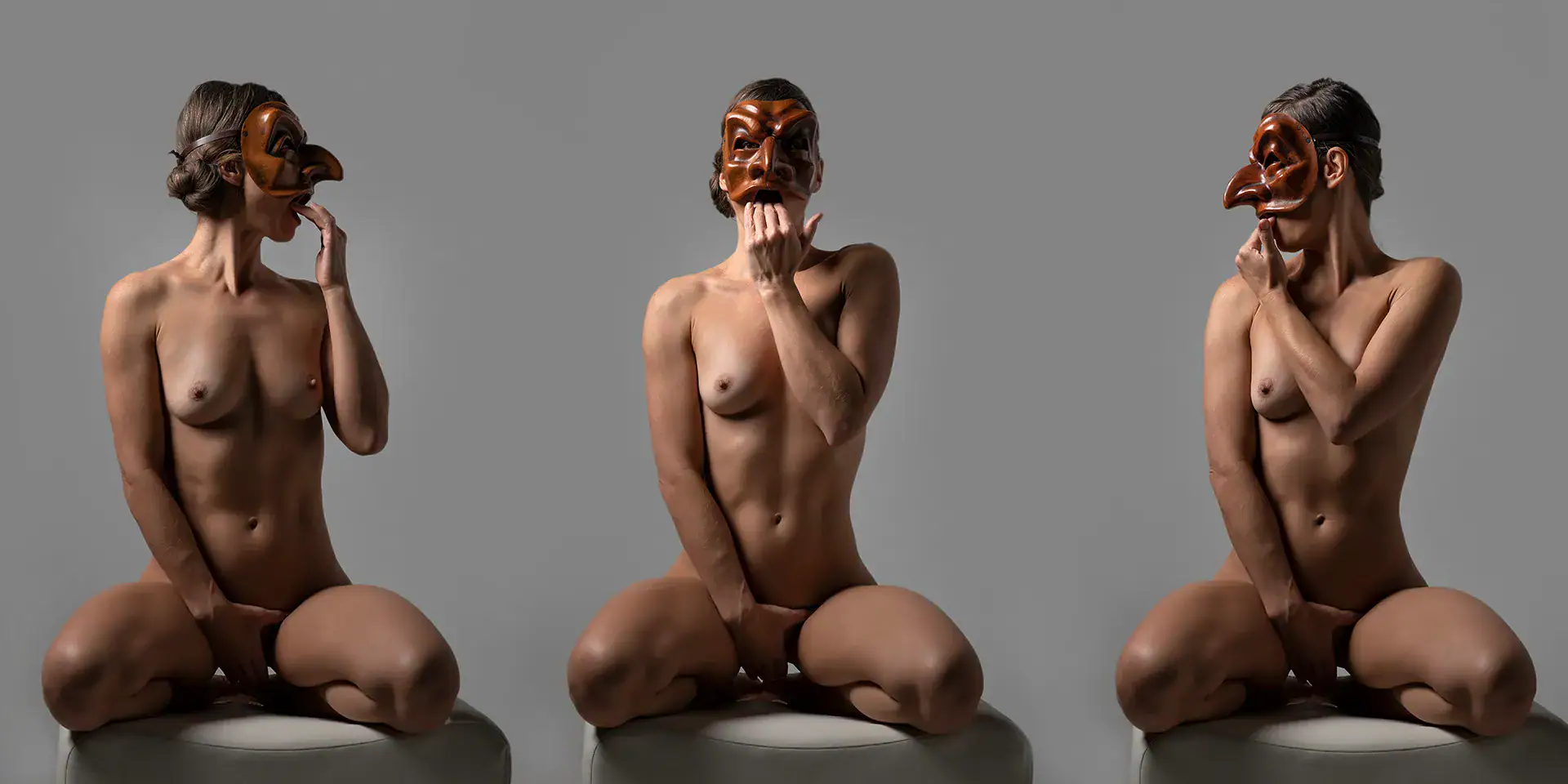 Conceptual Nude Triptych with Theatre Masks Three nude women wearing dramatic commedia dell’arte masks, posed in a triptych format against a grey background, seated with mirrored hand positions