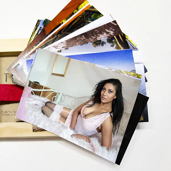 A collection of luxury boudoir photography prints from Boudoir Fusion Photography, featuring sensual portraits in a keepsake box for elegant client presentation or gifting.