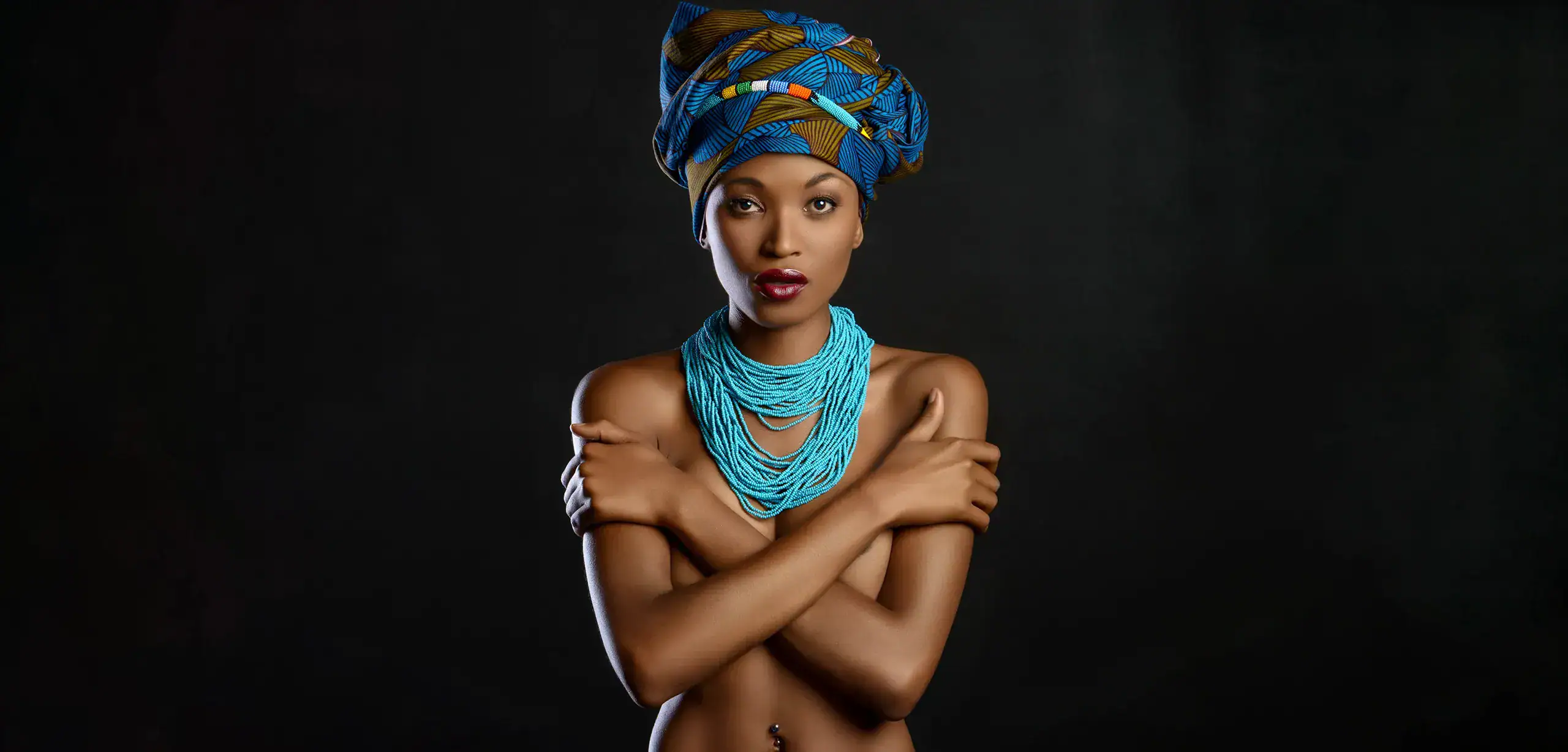 Boudoir Portrait Photography Johannesburg Studio boudoir portrait of a woman wearing a colourful African headwrap and turquoise beaded necklace, photographed by Boudoir Fusion in Johannesburg