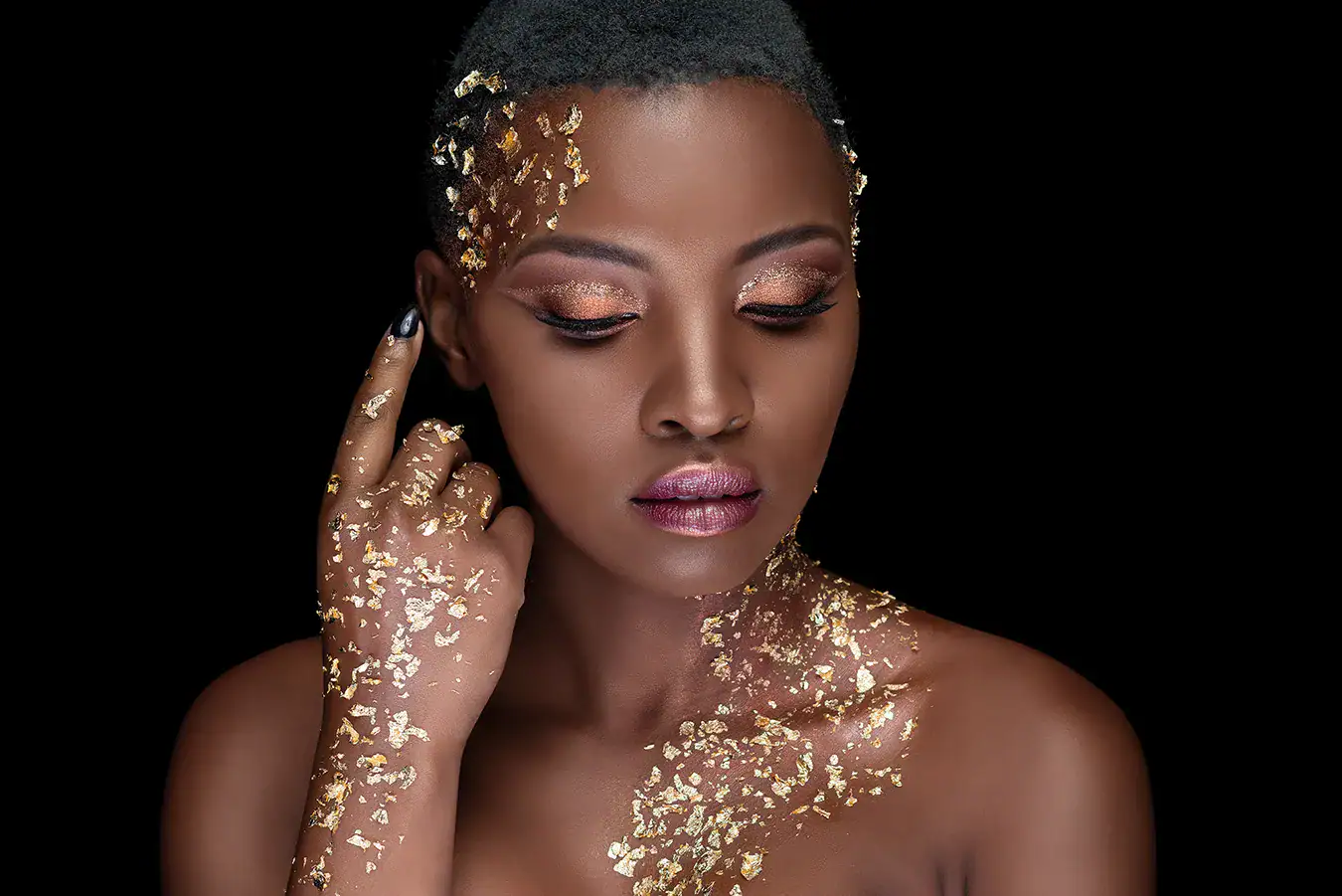 Gold Glitter Creative Beauty Portrait Creative beauty portrait of a woman decorated with gold glitter against a black background