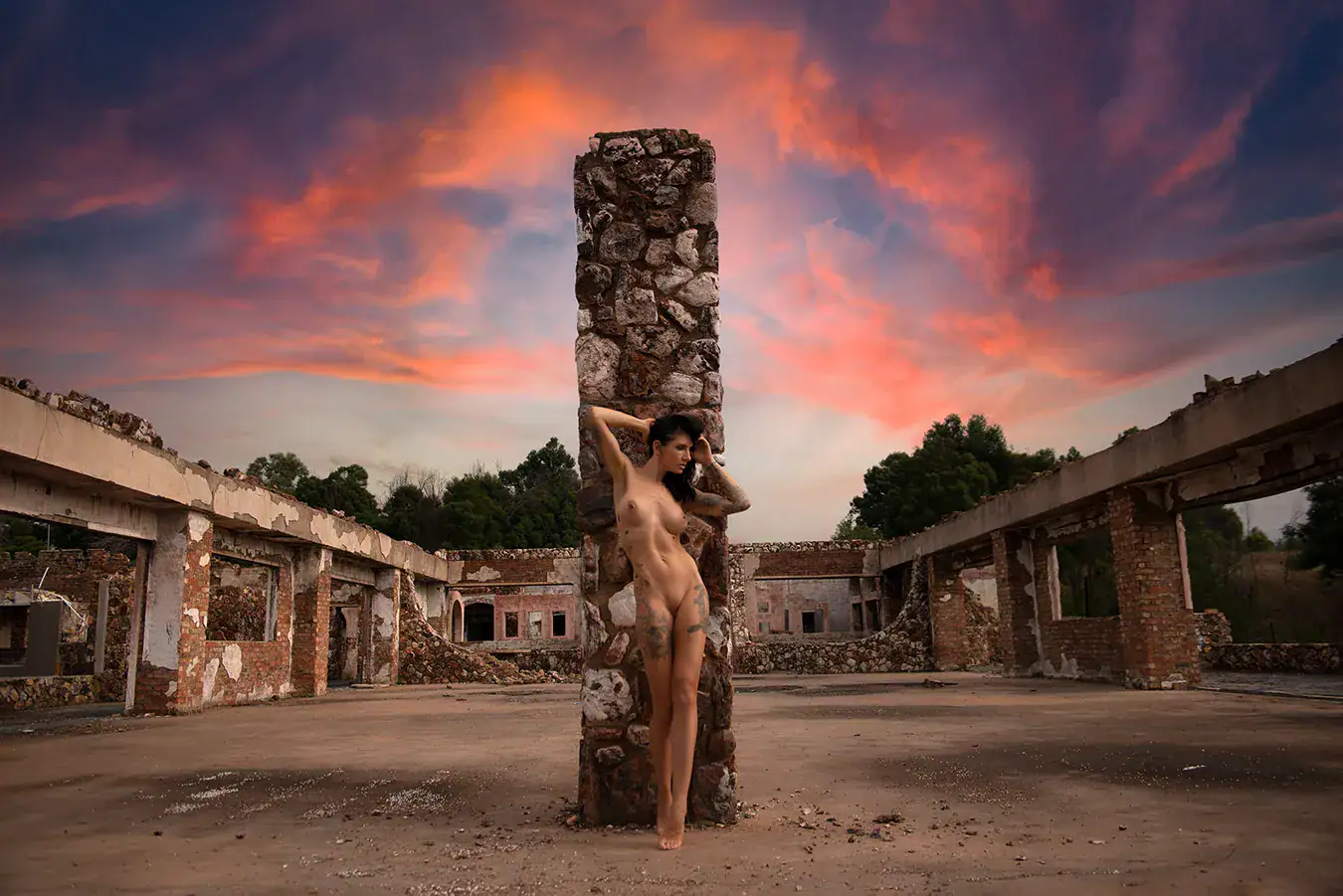 Conceptual Nude Photography on Location Artistic nude figure photographed with a sculptural prop in an abandoned industrial location
