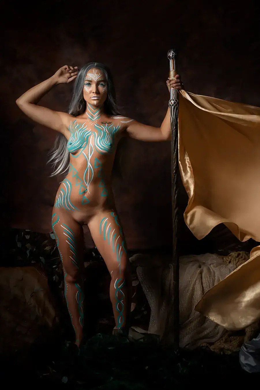 Tribal Warrior Body Art Photography Woman styled as a tribal warrior with turquoise body paint and dramatic gold fabric